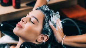 Mulher lavando o cabelo com carvão ativado